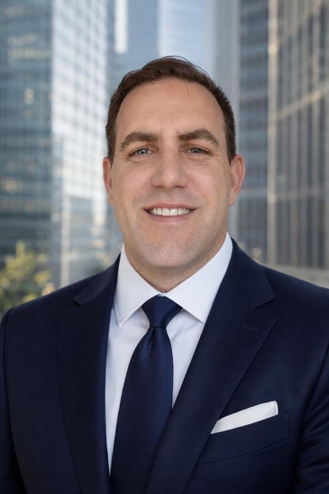 Professional headshot of Cooper Williams in a dark blazer and light blue shirt, smiling against a city skyline backdrop